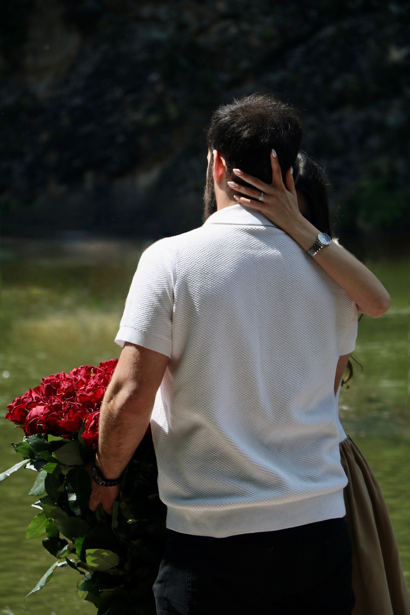 Boris and Liza embracing with red roses